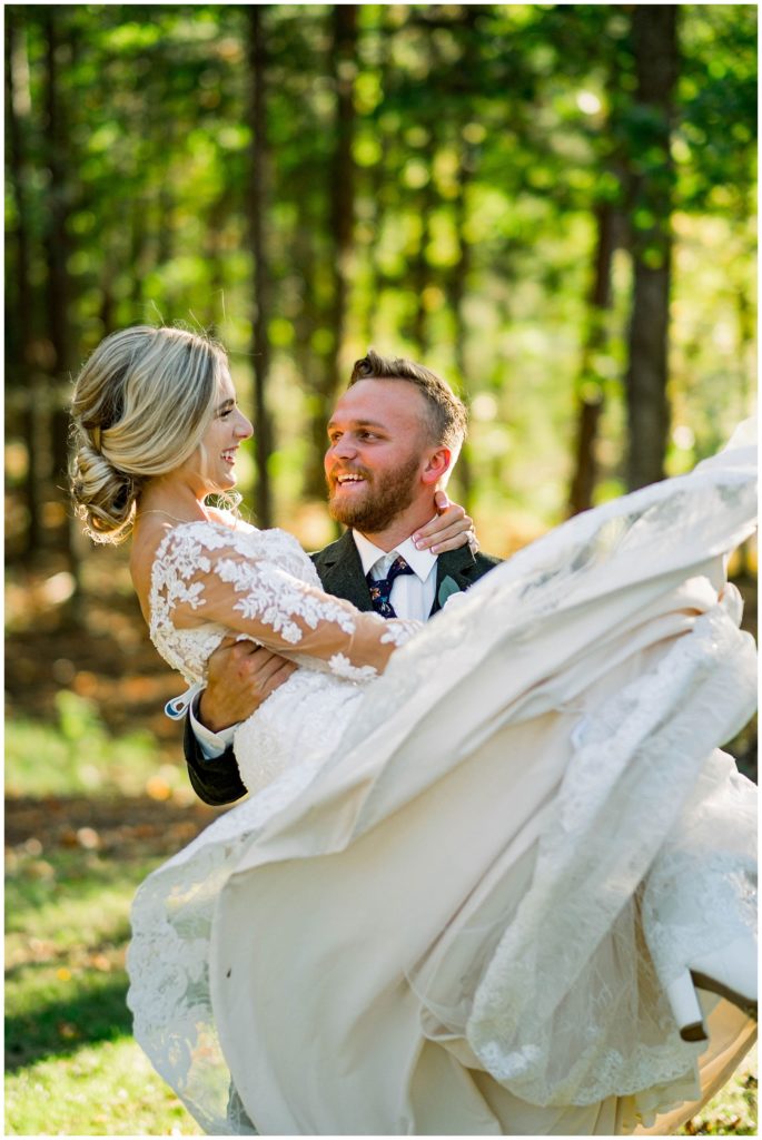 groom spinning bride around in outdoor fall wedding in knoxville