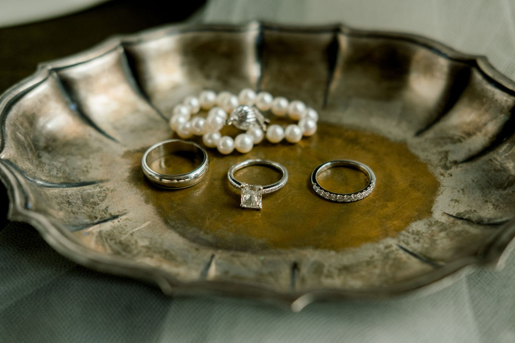 bride and groom's rings in dish for wedding details at micro wedding