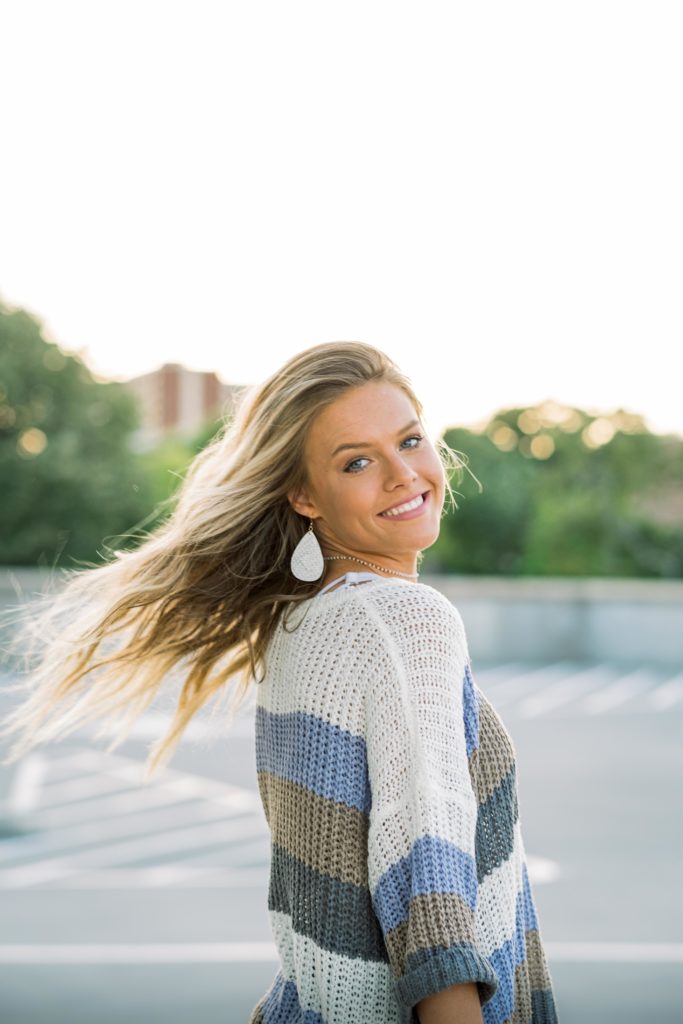 young Tennessee senior wearing striped sweater during fall portraits