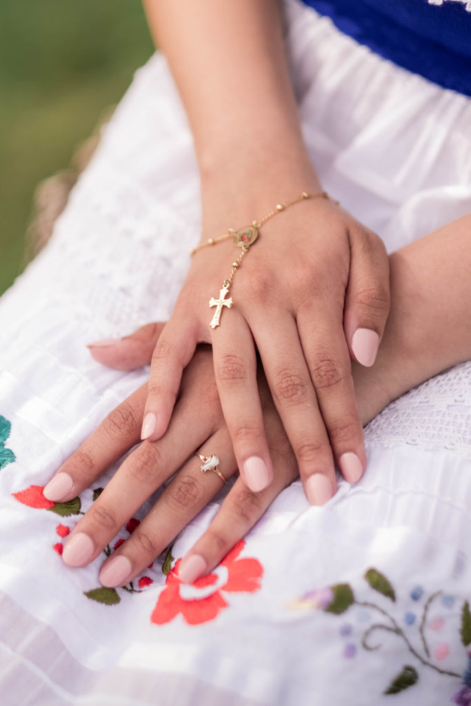Young woman's hands sitting on dress showing diversity 
