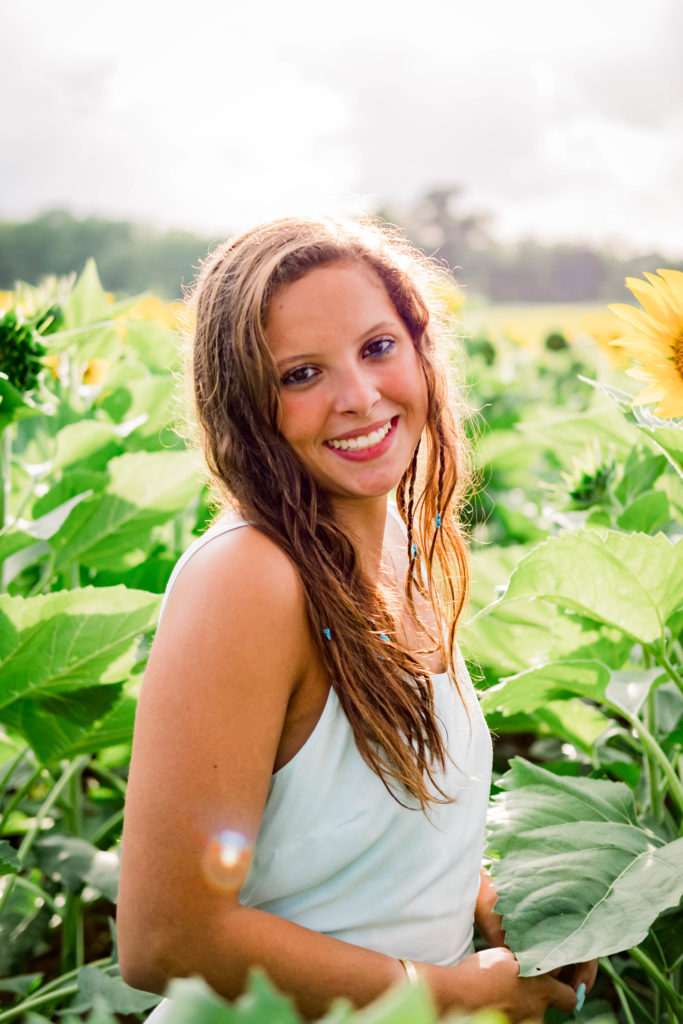 young senior smiling and laughing during Ooltewah sunflower session