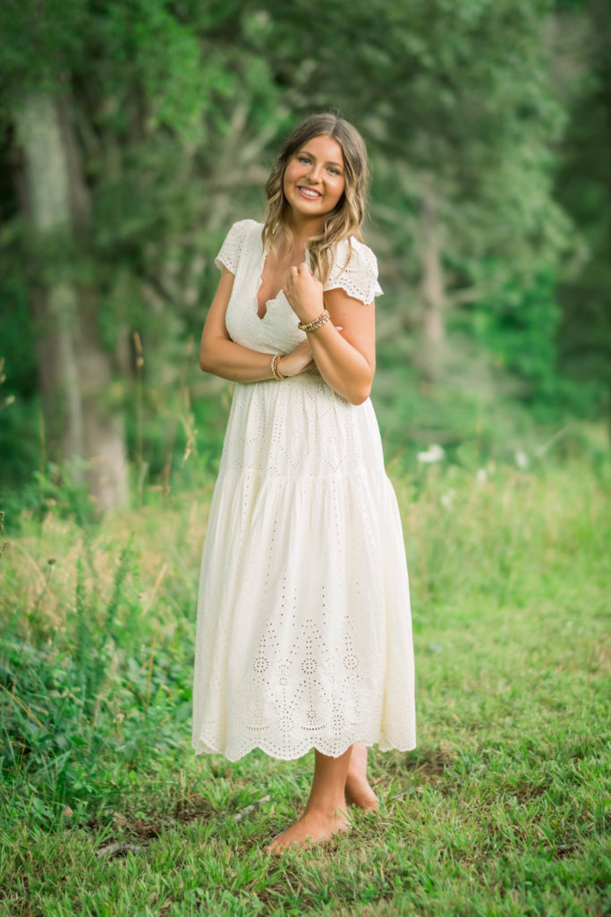 young girl wearing white dress  in field in Tennessee