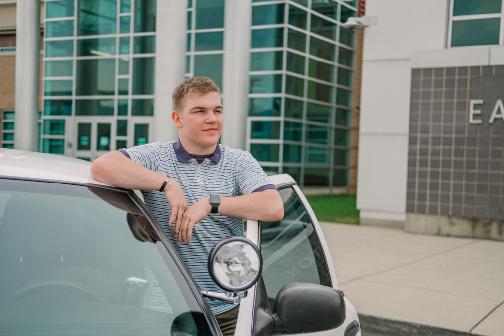 Young tennessee senior standing beside car during outdoor east hamilton senior session