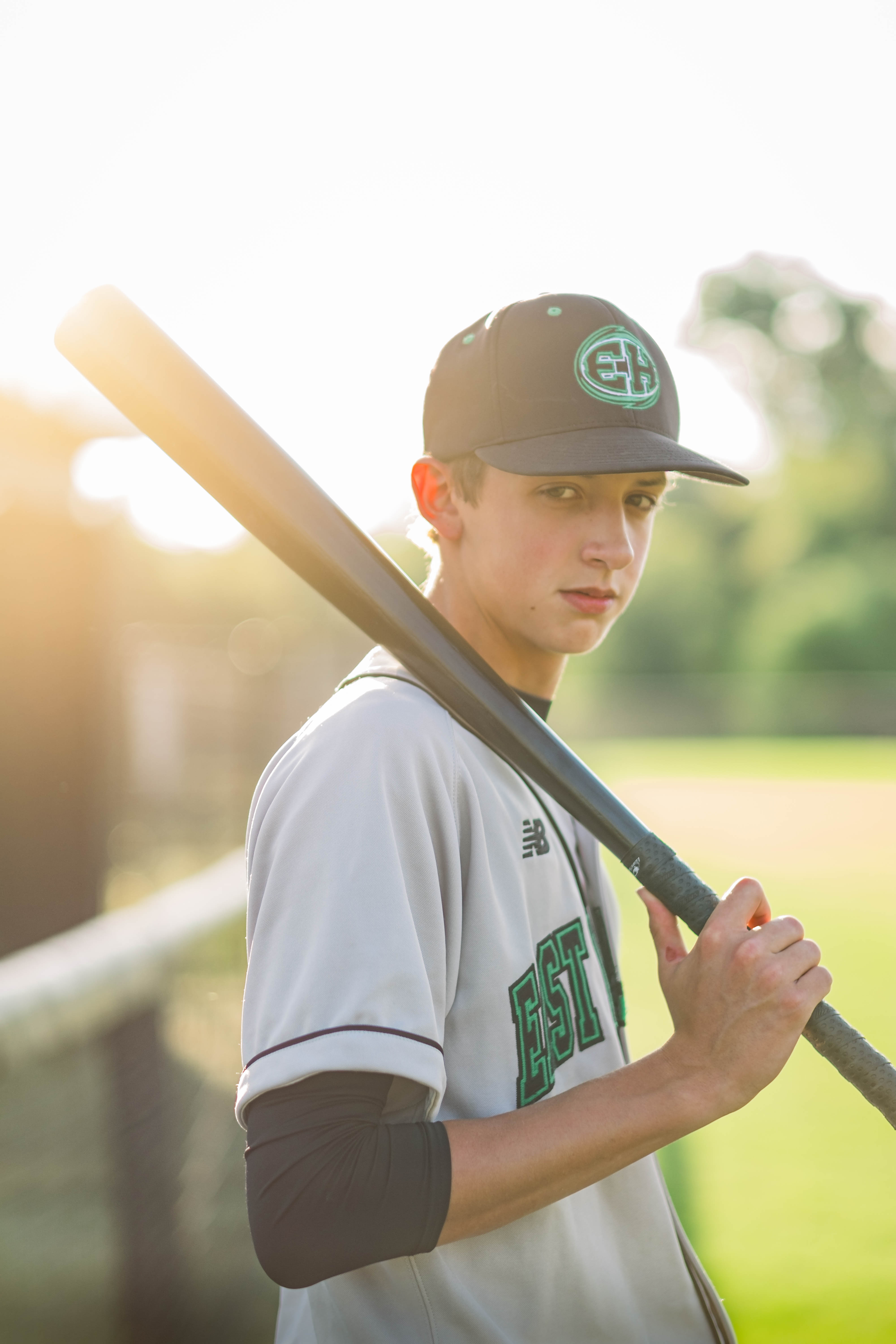 Young man holding baseball bat before senior pictures