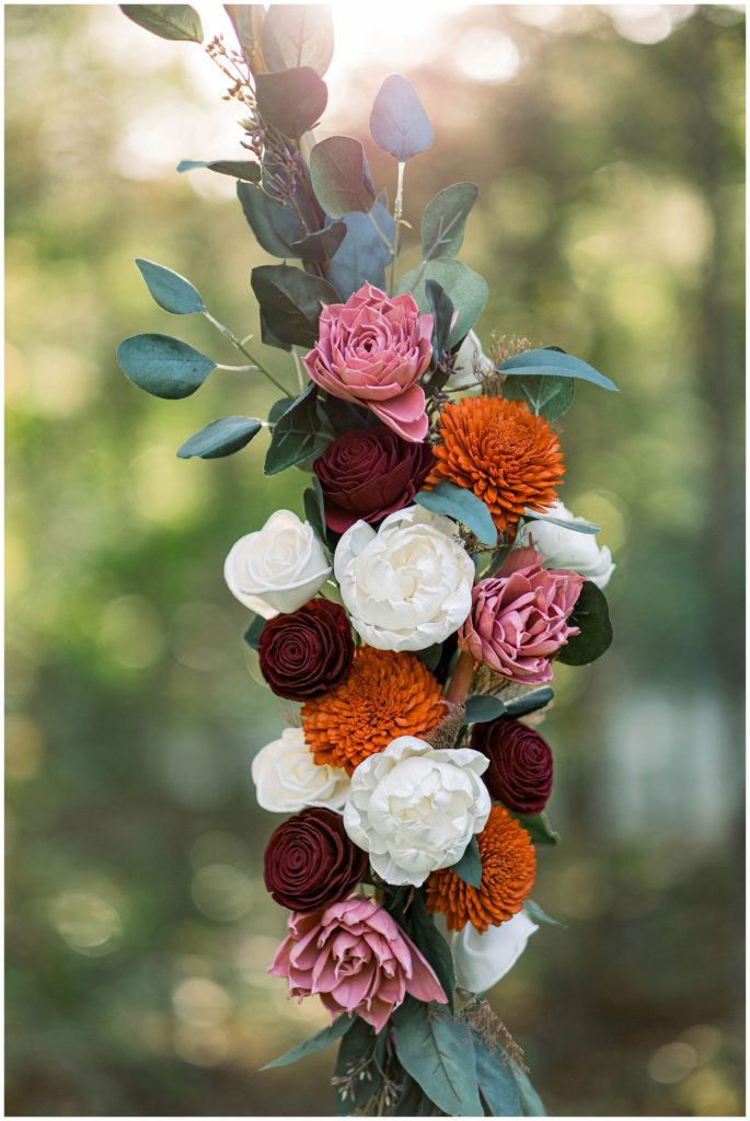 wooden flowers on wedding arch during tennessee wedding