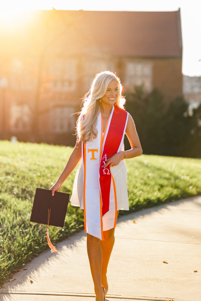 woman walking on college campus during graduation session