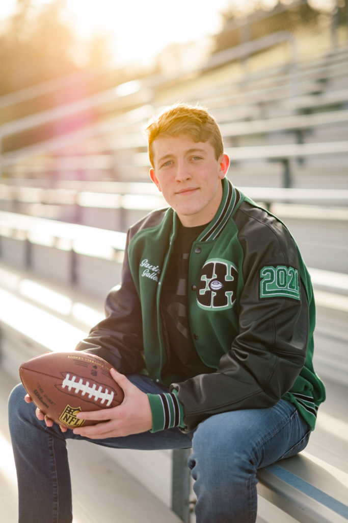 high school football player holding ball during chattanooga senior session