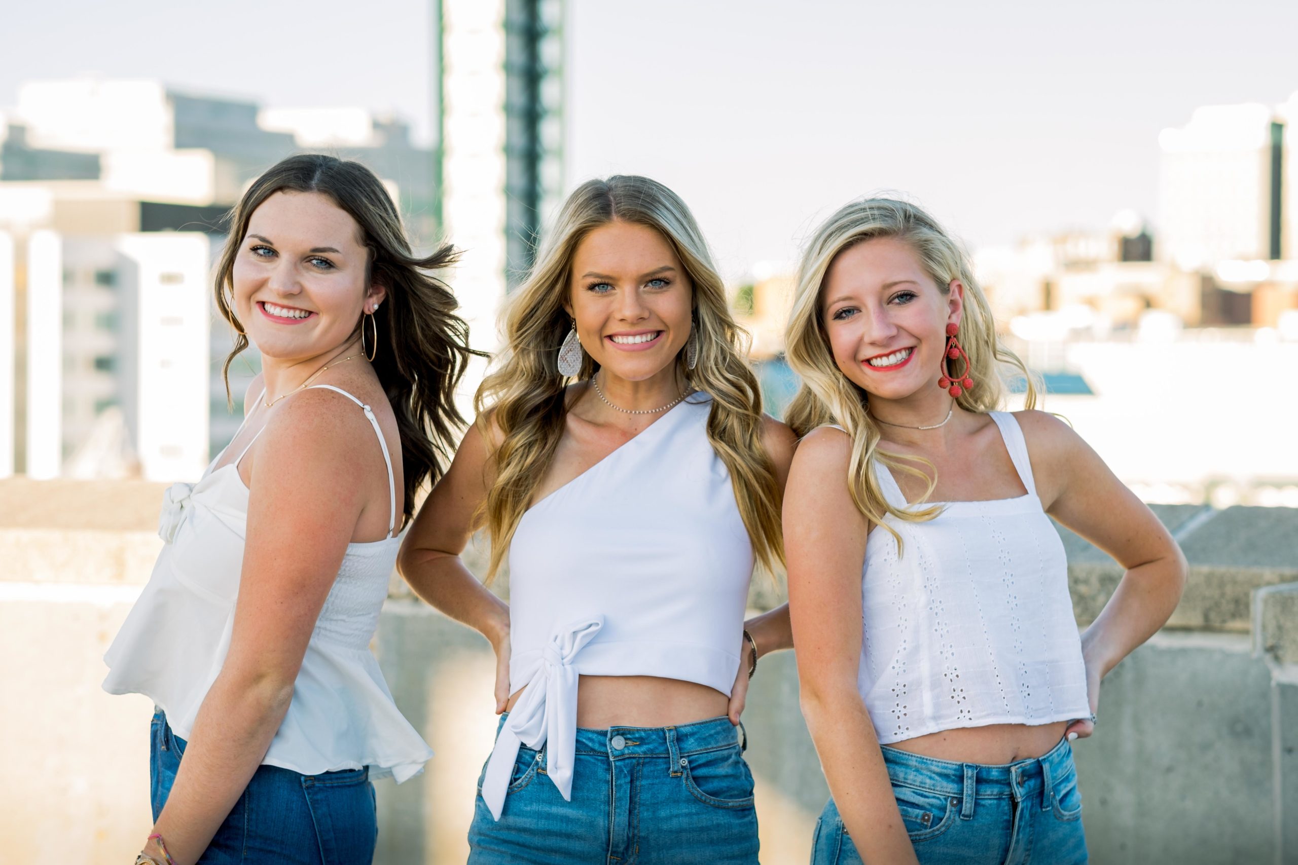 knoxville group senior session on top of a parking garage with a beautiful skyline in the background