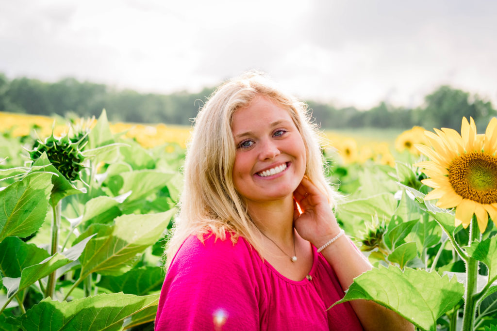 young high school student smiling and laughing during outdoor senior session