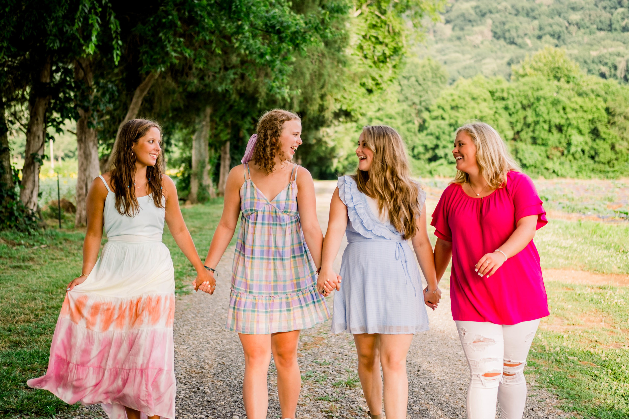 group of high school senior reps for Bess Pics walking and laughing together during outdoor photo shoot