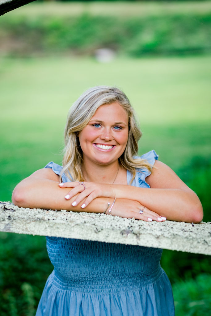 young woman smiling during outdoor senior portraits