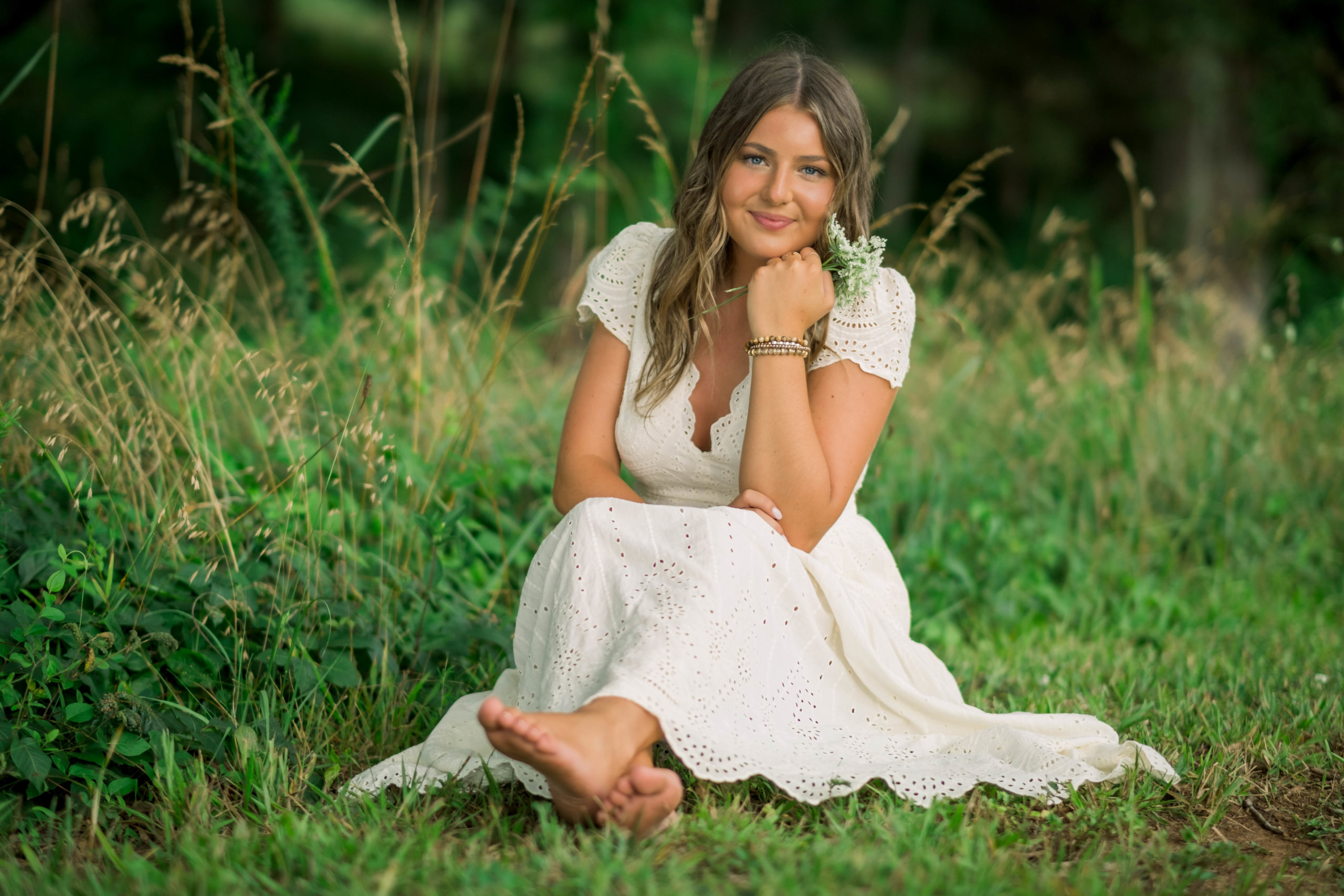Young tennessee senior celebrating senior year in outdoor session with white dress on