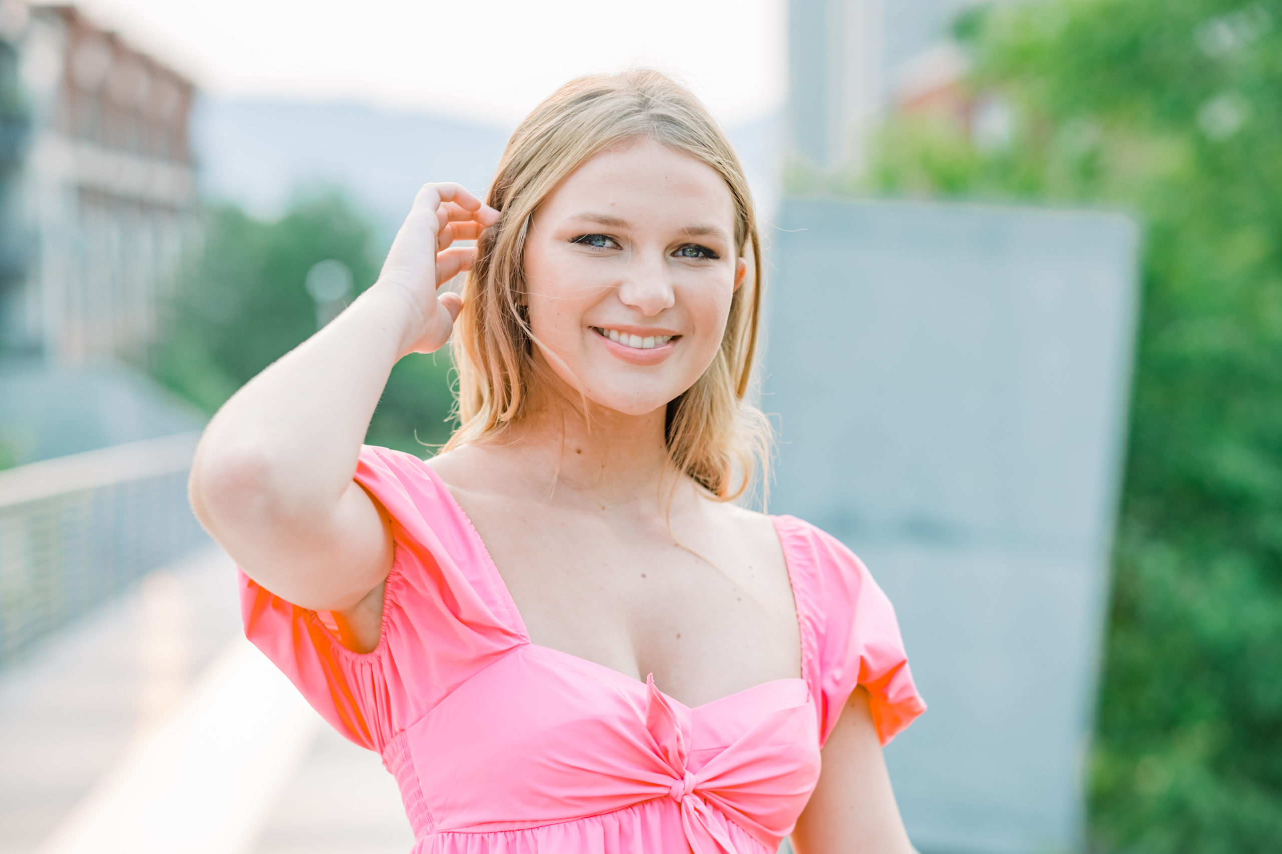 woman wearing pink top smiling at camera