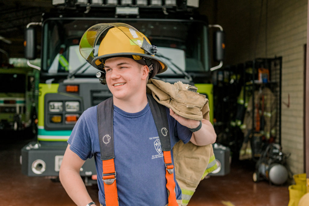 Young tennessee senior wearing volunteer firefighter gear
