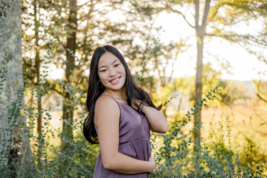Young Chattanooga senior wearing purple dress smiling during outdoor senior session
